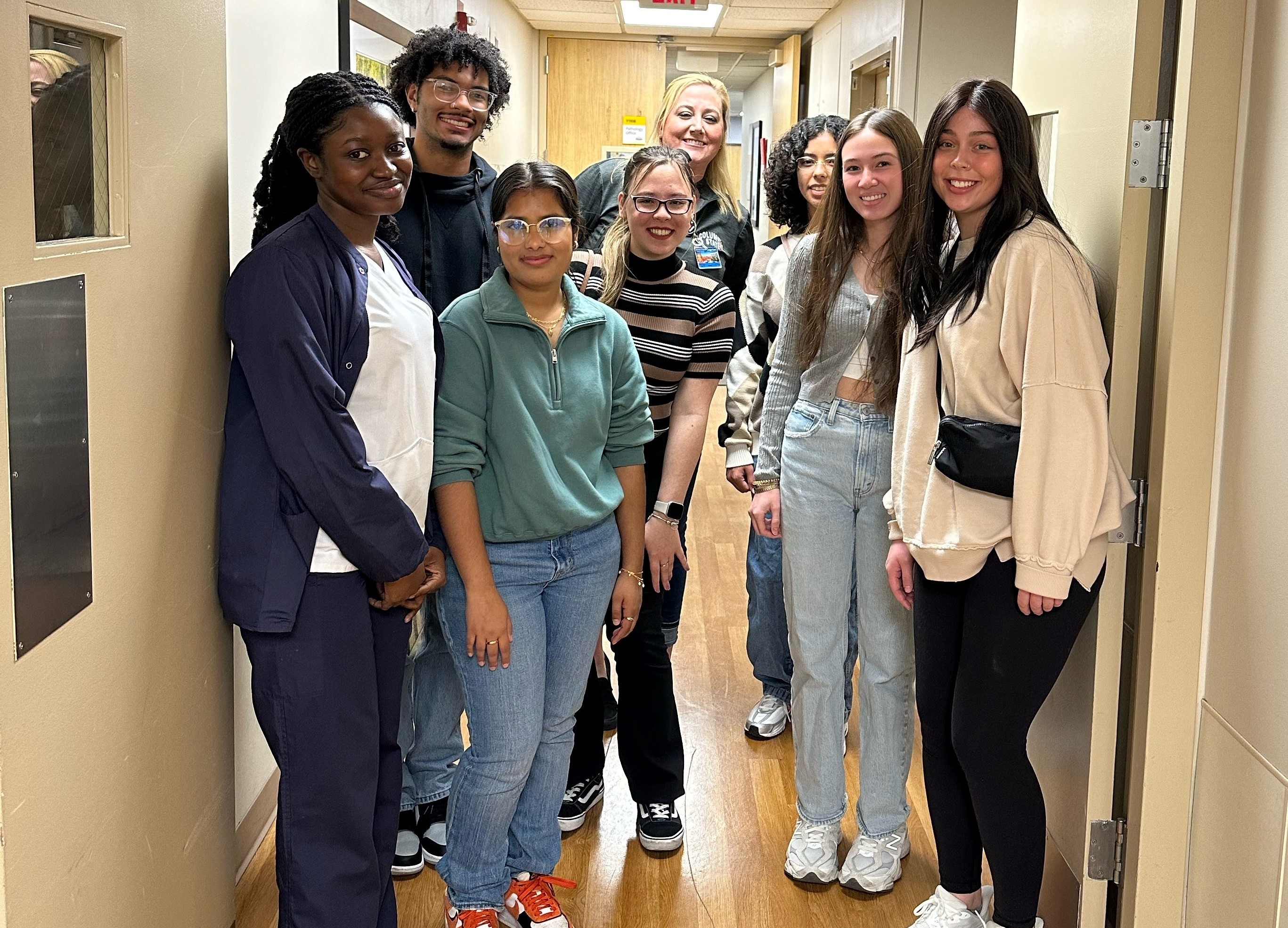 Meghan Blackford, assistant professor & Multi-Skilled Health program coordinator, is in the back center with seven Health and Human Services Honors students in front of her. 