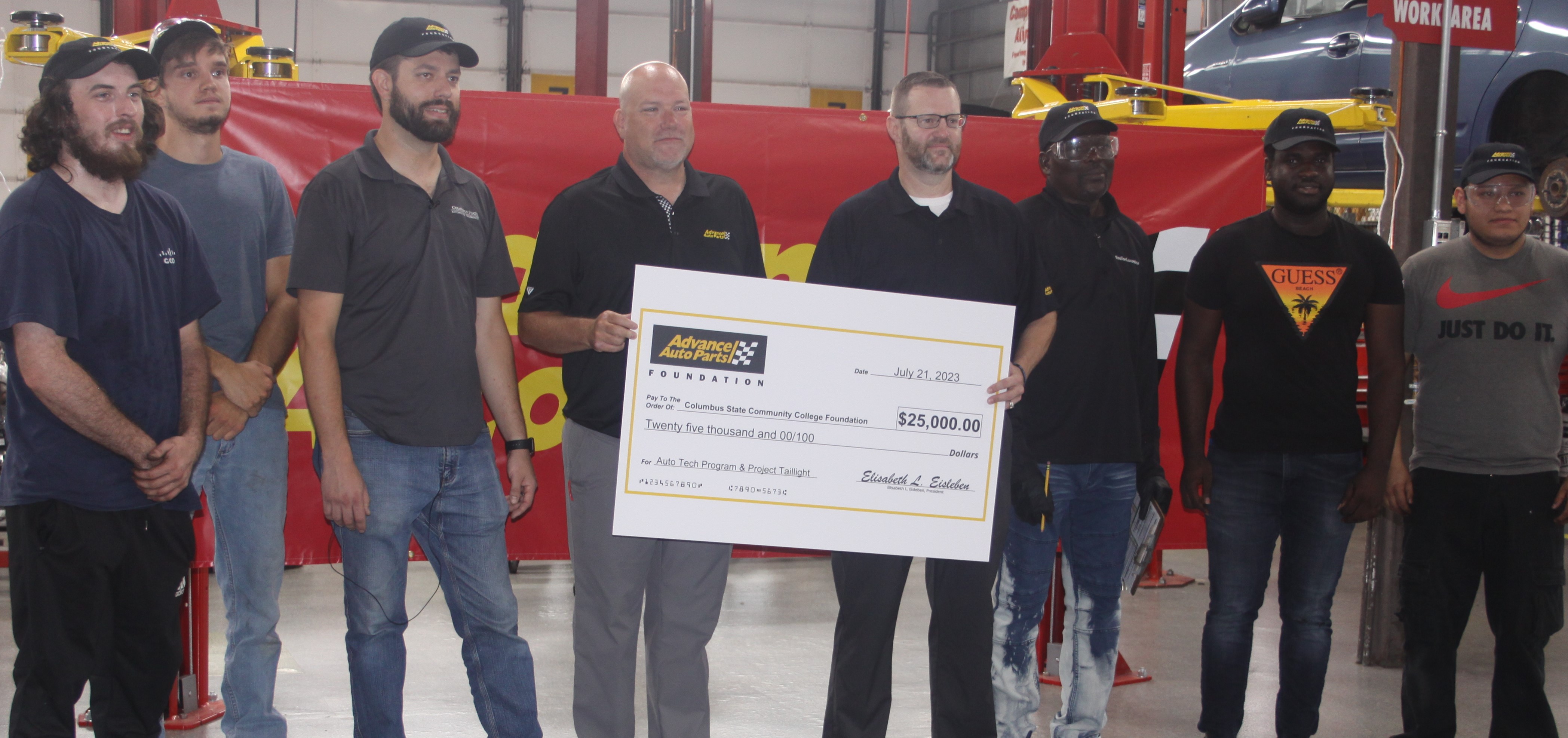 A $25,000 check from the Advance Auto Parts Foundation is presented to Columbus State on July 21 in the Automotive Technology Lab. From left to right: Robert Gonzalez, student; Alex Stewart, student; Ian Andrews, associate professor; Jason Lucas, Advance Auto Parts; John Bowling, Advance Auto Parts; Mouhamed Elba, student; Isaac Darko Boamah, student; and Daniel Solano, student. 