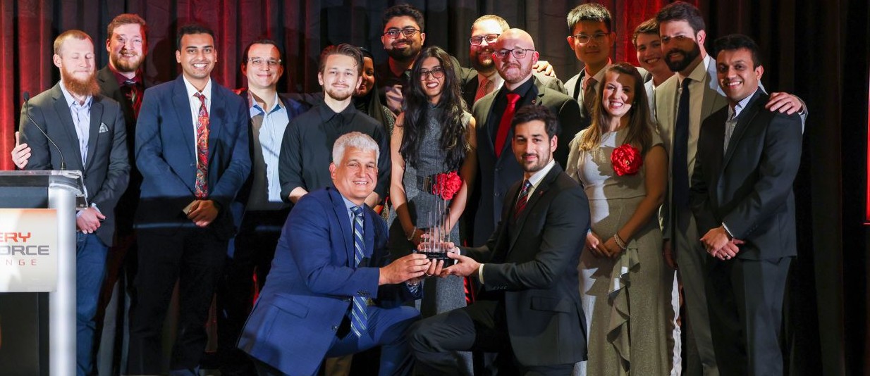 students and faculty advisers from Columbus State and Ohio State gather during the first-place award presentation in Detroit on May 8. With them, and kneeling on the left, is Michael Bly, senior vice president of Stellantis North America.