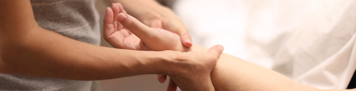 Student massaging someone's wrist