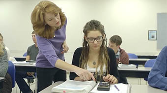Instructor helping student in class.