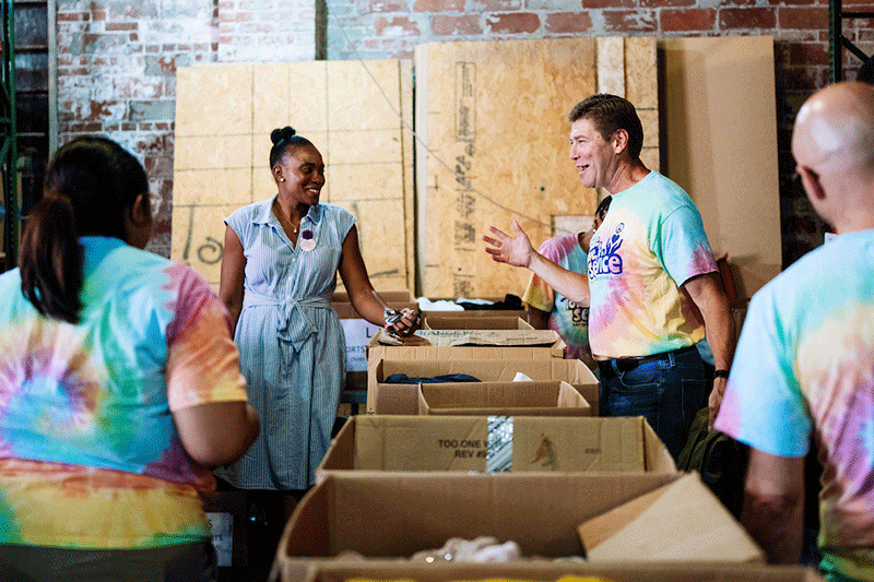 
 Columbus State President David Harrison, right, engages with Habiba Bankston, executive director of Dress for Success Columbus, during Day of Service volunteerism with Student Engagement and Inclusion student ambassadors at the nonprofit, which supports women in need of workplace-appropriate attire. 
