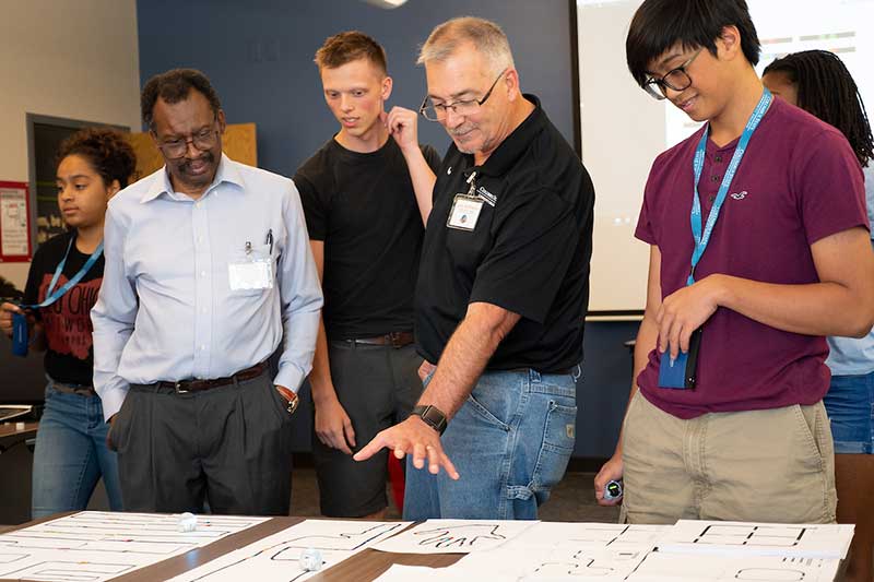 
Columbus State assistant professor Larry McWherter, who will lead the National IT Innovation Center initiative, demonstrates biometric cybersecurity interfaces to participants in GenCyber Summer Camp, which recruits high school students to learn more about potential information systems technology careers.
