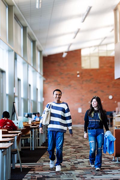 Students walking in library