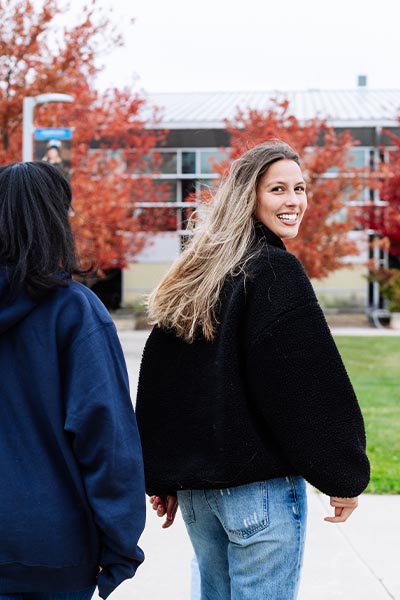 Female student walking towards Molher hall.