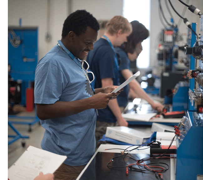Photos from the Advanced Automation Summer Camp, Summer 2017. High school students are doing various activities in the Integrated Systems Technology (IST) Lab on campus. Related to the Modern Manufacturing Work Study (MMWS) program. NOTE: Students should be wearing safety goggles, some are not so use photos with caution. NOTE: Students should be wearing safety goggles, some are not so be cautious when using the photo depending on visibility level.
