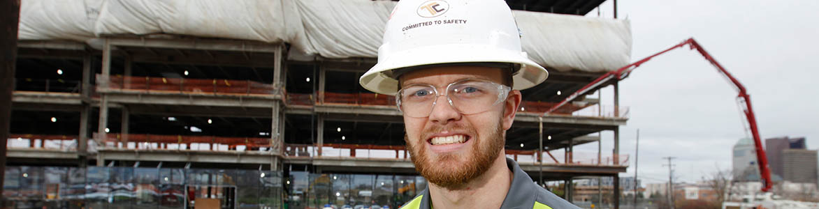 Photo of graduate at construction site
