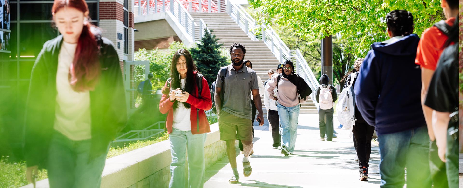 Students walking on campus during a sunny day