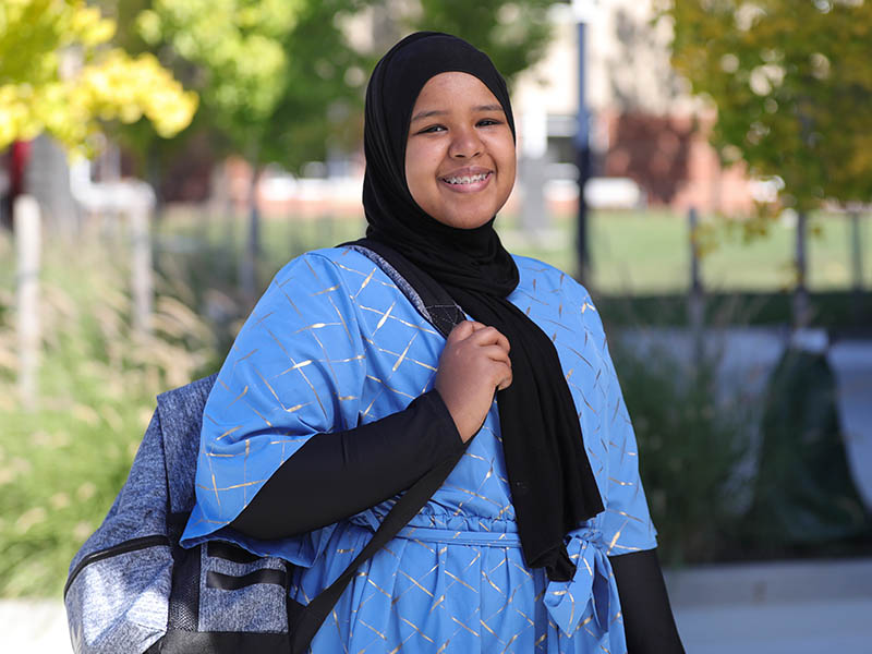 Woman smiling wearing backpack at Columbus State.