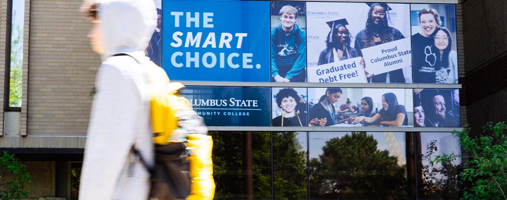 Student walking past Madison Hall entrance