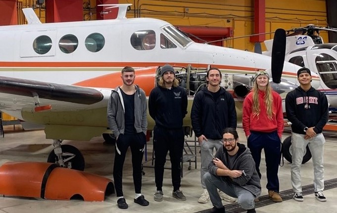 Above at Bolton Field, left to right, students Austin Novak, Jackson Wollenburg, Marcus Zullo, Abigail Rhodes, and Jonathan Sanchez. Kneeling: Noah Alloy.
