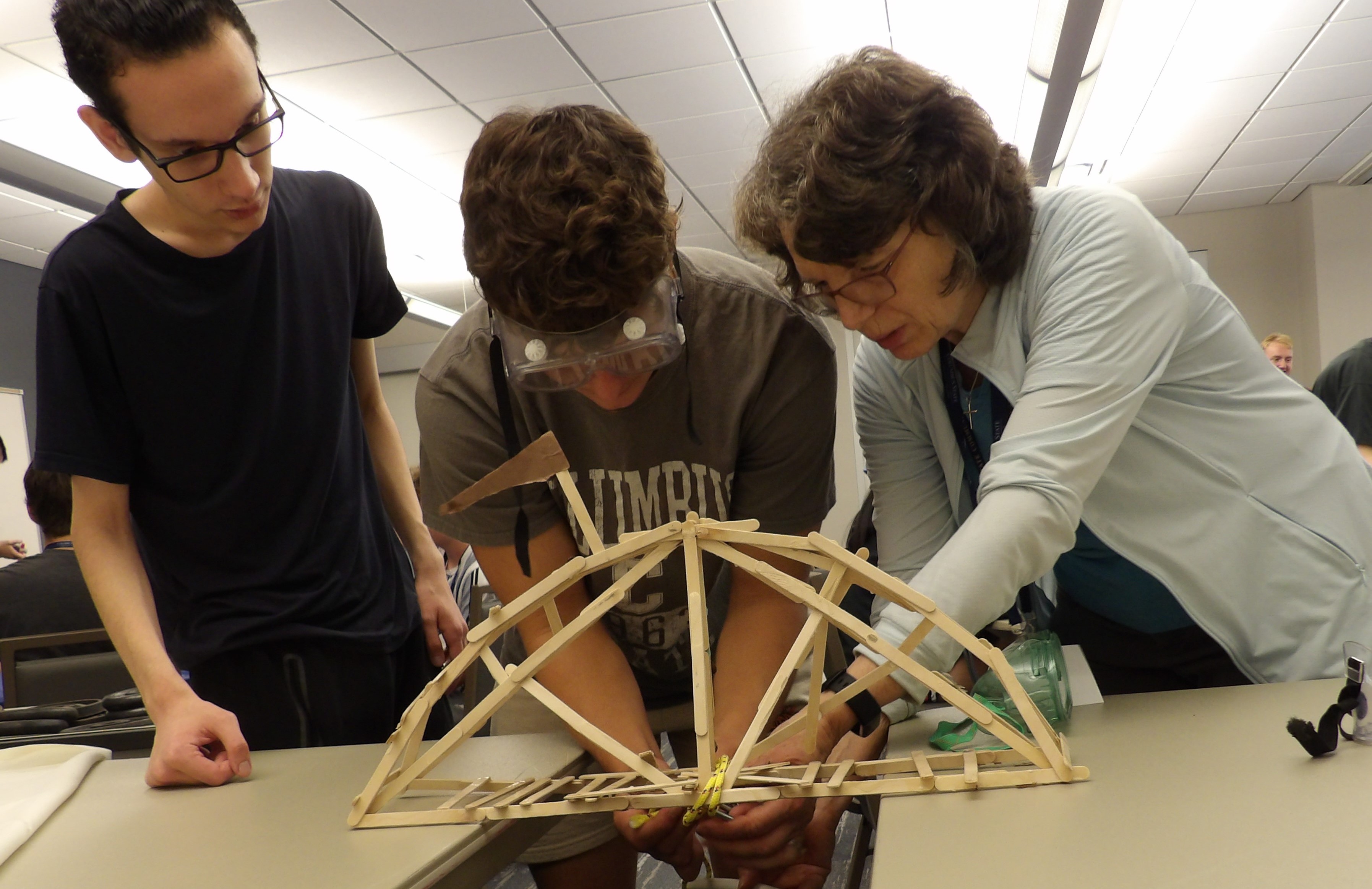 Above left, students in the STEM Summer Bridge Program. Right, Valerie Powers, retired assistant professor of Biological & Physical Sciences assists two students