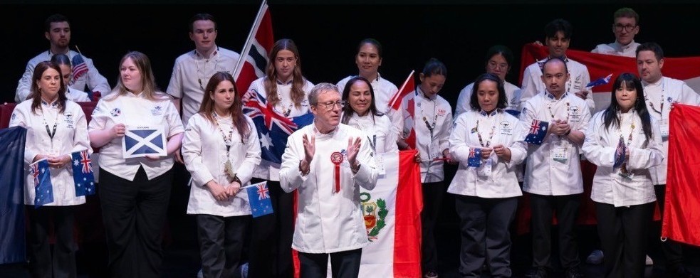 Young chefs from around the world attended the biannual Worldchefs Congress & Expo in Wales in May. Columbus State student Ben Major, back left, holds a small American flag.